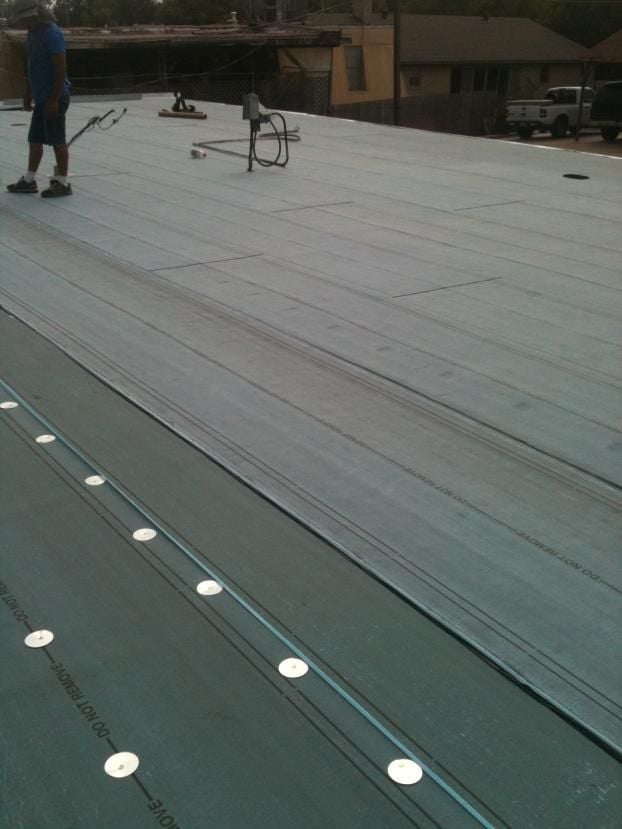 Before a completed commercial reroofing service project in the  area